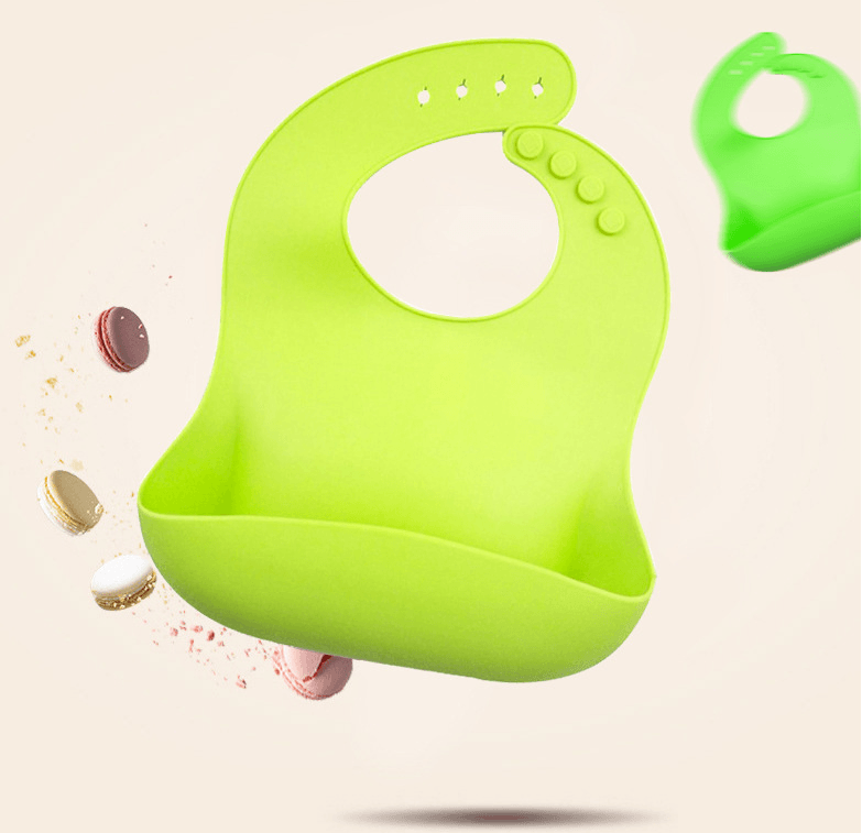 Bright green soft silicone baby bib floating with macarons, emphasizing easy clean & mess-free mealtime for babies.